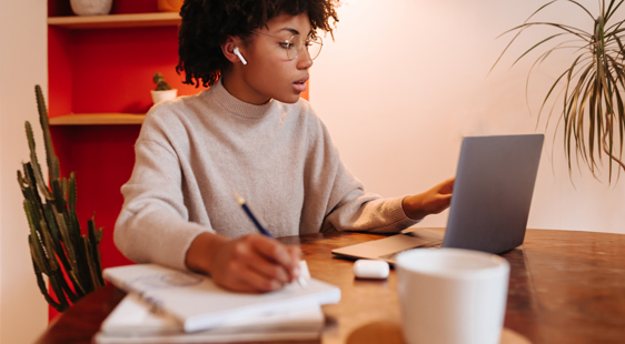 Young black woman studying online at home.