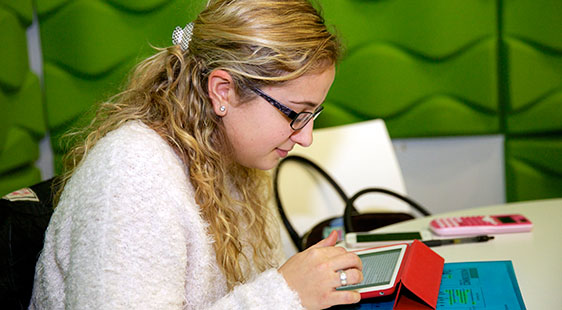 A female staff member helping a female student at a computer